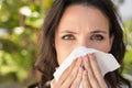 Pretty brunette blowing her nose Royalty Free Stock Photo