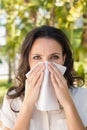 Pretty brunette blowing her nose Royalty Free Stock Photo