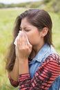 Pretty brunette blowing her nose Royalty Free Stock Photo