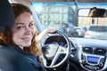 Pretty brunette driving car, looking back at camera Royalty Free Stock Photo