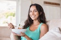 Pretty brunette eating salad on couch Royalty Free Stock Photo