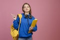 Pretty brunette female standing, pointing by finger. Royalty Free Stock Photo