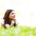 Pretty brunette girl laying on grass Royalty Free Stock Photo