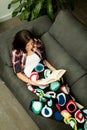 Pretty brunette girl reading on the sofa Royalty Free Stock Photo