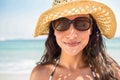 Pretty brunette looking at camera at the beach