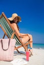 Pretty brunette looking at camera on deck chair Royalty Free Stock Photo