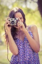 Pretty brunette in the park using retro camera Royalty Free Stock Photo