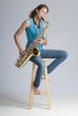 Pretty Brunette Playing Saxophone Royalty Free Stock Photo