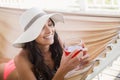 Pretty brunette relaxing on a hammock and drinking cocktail Royalty Free Stock Photo