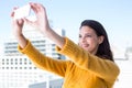 Pretty brunette taking photos with her smartphone Royalty Free Stock Photo