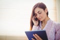 Pretty brunette using her tablet Royalty Free Stock Photo