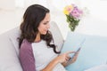 Pretty brunette using her tablet Royalty Free Stock Photo