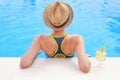 Pretty brunette woman enjoying lemonade in a swimming pool Royalty Free Stock Photo