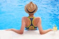 Pretty brunette woman enjoying lemonade in a swimming pool Royalty Free Stock Photo