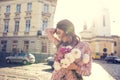 Pretty brunette woman with fluttering hair in wind and sun flare