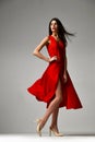 Pretty brunette woman in formal red dress stiletto heels shoes Royalty Free Stock Photo