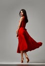 Pretty brunette woman in formal red dress stiletto heels shoes Royalty Free Stock Photo