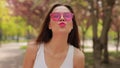 Pretty brunette woman with pink lips blowing kiss