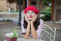 Pretty brunette woman in a striped t-shirt drinking red wine in outdoor cafe and dreaming Royalty Free Stock Photo