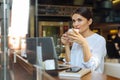 Pretty businesswoman drinking latte in cafe Royalty Free Stock Photo