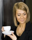 Pretty businesswoman having her morning coffee