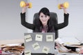 Pretty businesswoman lifting two dumbbells