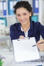 pretty businesswoman offering to sign contract on clipboard Royalty Free Stock Photo