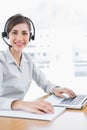 Pretty call centre agent working at desk Royalty Free Stock Photo