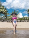 A pretty and carefree asian lady at a tropical beach, posing with her new bikini. At Nasugbu, Batangas, Philippines Royalty Free Stock Photo