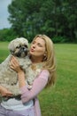 Pretty casual woman with cute little dog outdoors