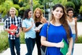 Pretty caucasian female student with group of international stud Royalty Free Stock Photo