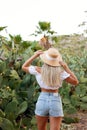 Pretty caucasian teenager in a field of cactuses