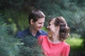 Pretty caucasian love couple walking in the green summer park, having smiles, kisses and hugs Royalty Free Stock Photo