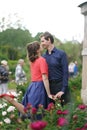 Pretty caucasian love couple walking in the green summer park, having smiles, kisses and hugs Royalty Free Stock Photo