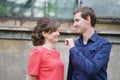 Pretty caucasian love couple walking in the green summer park, having smiles, kisses and hugs Royalty Free Stock Photo