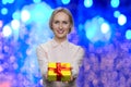 Pretty caucasian woman giving Christmas gift box.