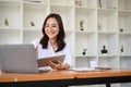 Pretty Asian businesswoman working, planning her marketing project and using laptop Royalty Free Stock Photo