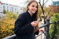 Pretty cheerful girl happily looking in camera walking in city park Royalty Free Stock Photo