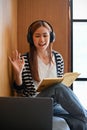 A pretty young Asian female college student using laptop computer to take an online class Royalty Free Stock Photo