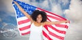 Composite image of pretty cheering girl in white top holding american flag