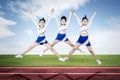 Pretty cheerleader team performing in the field Royalty Free Stock Photo