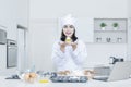 Pretty chef showing cupcake Royalty Free Stock Photo