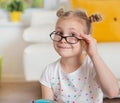 Pretty child girl at home dreaming of travel and tourism, exploring the world and globe Royalty Free Stock Photo