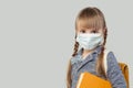 Pretty child girl in medical protective face mask on white background