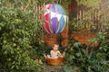 Pretty child riding hot air balloon. Boy having fun flying up.