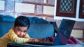 pretty child sitting at the table looking at camera screen and smiling. enjoying distance learning. close up Royalty Free Stock Photo