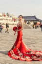 Pretty Chinese girl in red wedding dress in the Temple of Heaven in Beijing