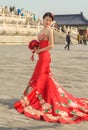 Pretty Chinese girl in red wedding dress in the Temple of Heaven in Beijing