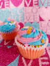 Pretty chocolate and vanilla cupcakes with colorful frosting and sprinkles on a love background Royalty Free Stock Photo
