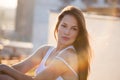 Pretty city girl portrait at sunset backlight at top of building